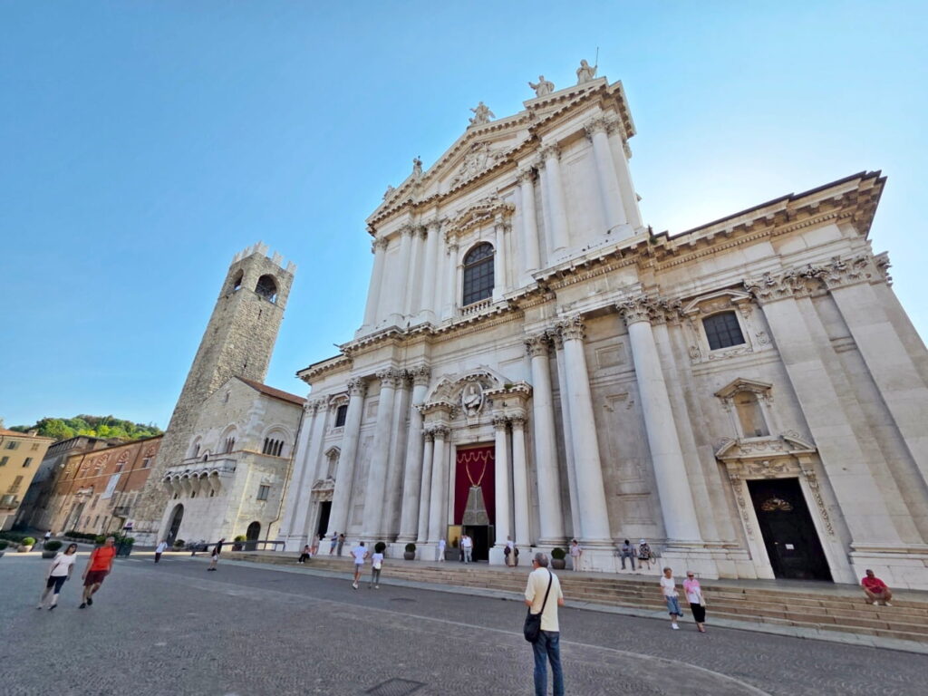 Cathedral of Santa Maria Assunta facade in Brescia, Italy, with baroque columns and square in front