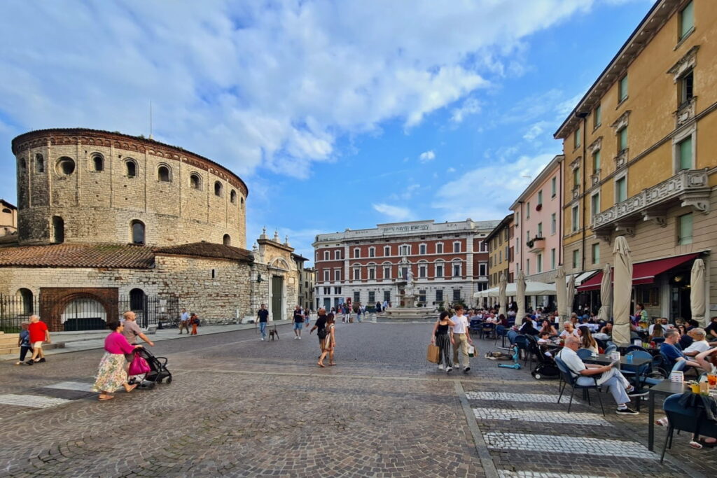 Piazza Paolo VI in Brescia, Italy, with Duomo Vecchio and outdoor cafes in the historic center