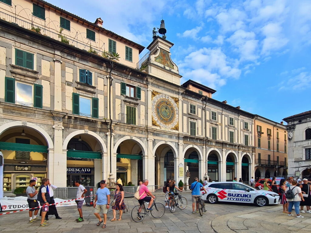 Piazza della Loggia in Brescia, Italy, with arcades and astronomical clock on historic building facade