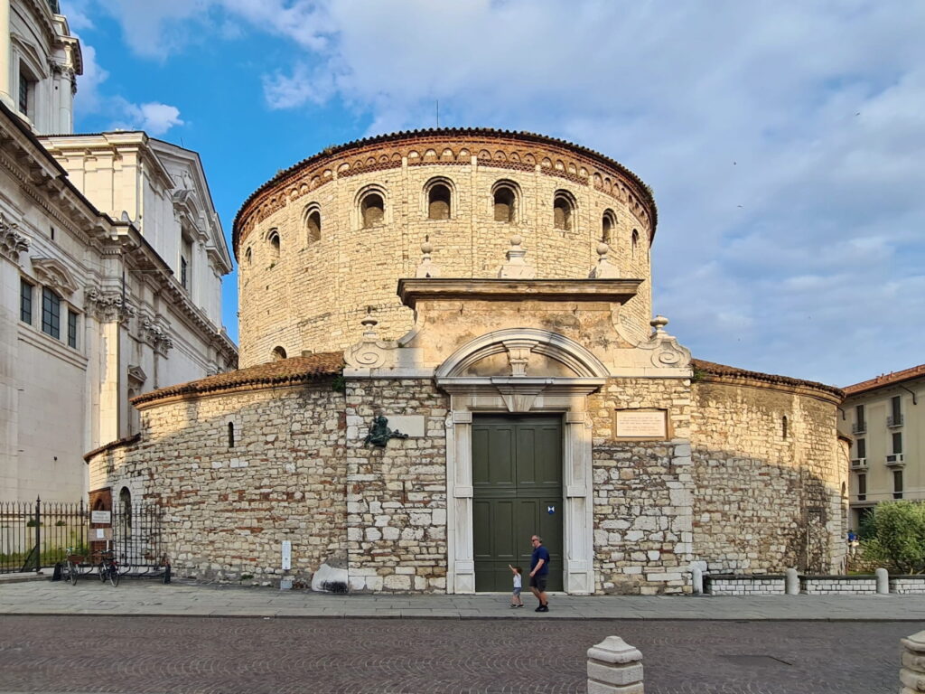 The circular Romanesque exterior of Duomo Vecchio made of light stone in Brescia, Italy.